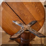 F38. Oak pedestal table with glass top. 